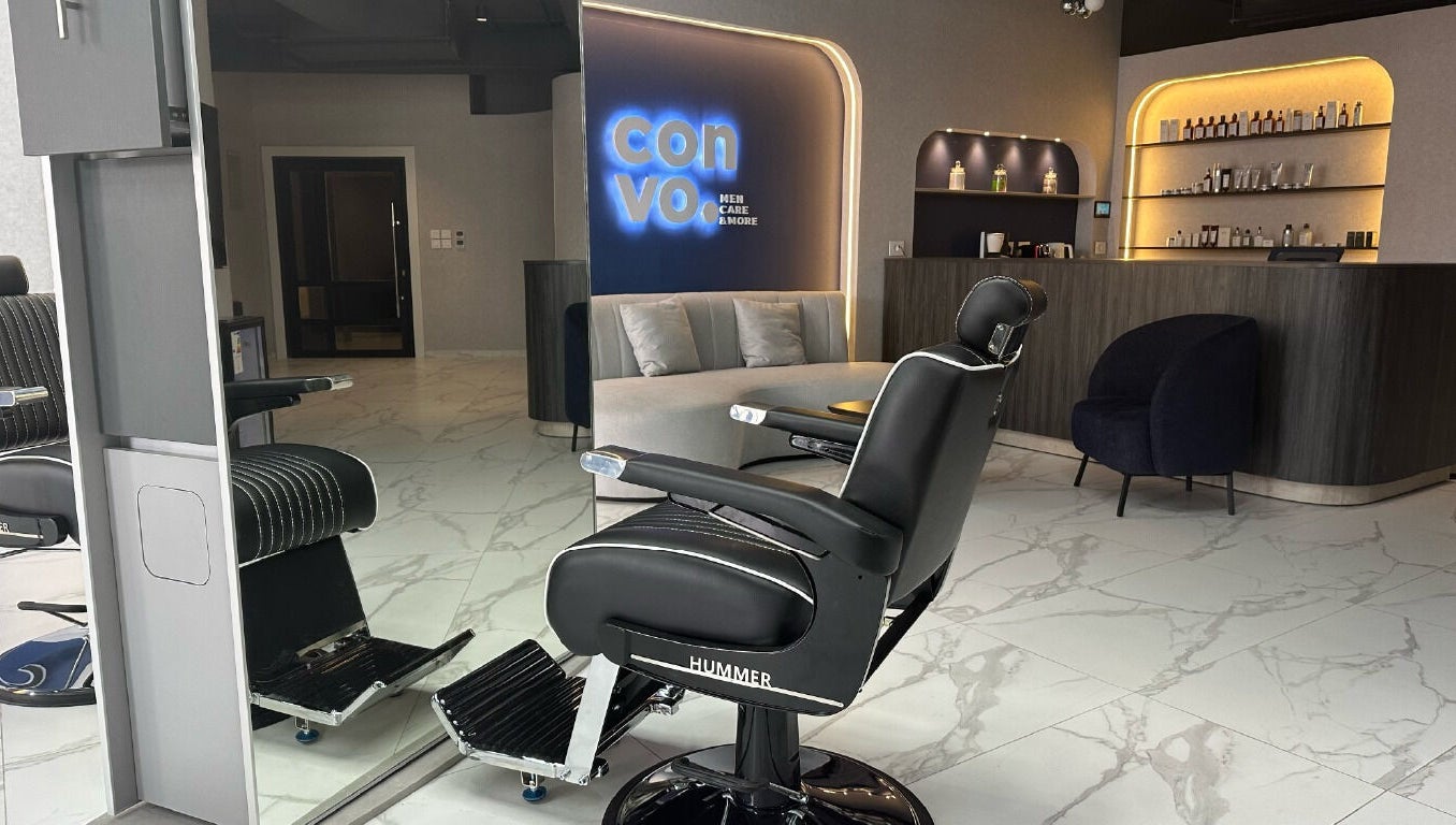 Sleek barbershop interior at Convo in Amman, Amman Governorate, JO featuring modern chairs and stylish decor.