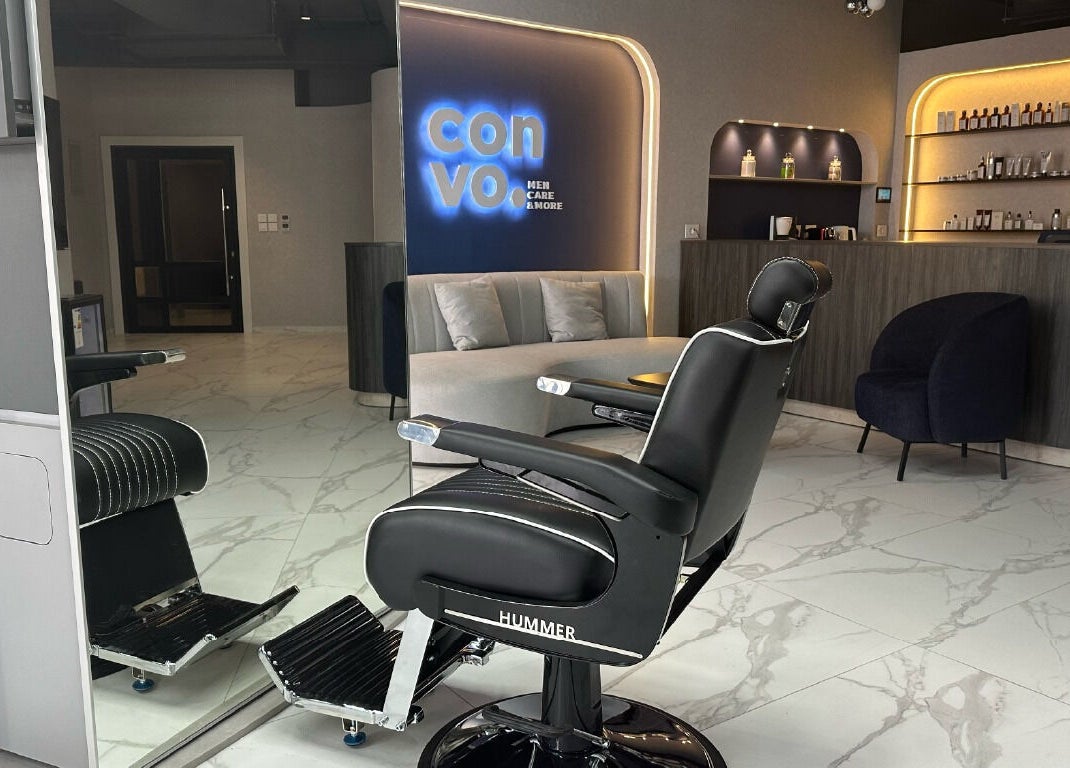 Sleek barbershop interior at Convo in Amman, Amman Governorate, JO featuring modern chairs and stylish decor.