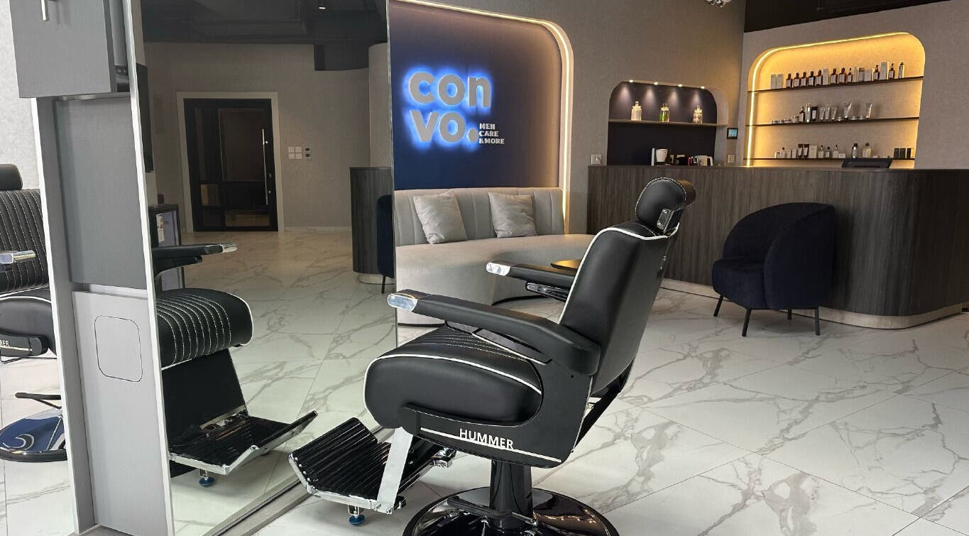 Sleek barbershop interior at Convo in Amman, Amman Governorate, JO featuring modern chairs and stylish decor.
