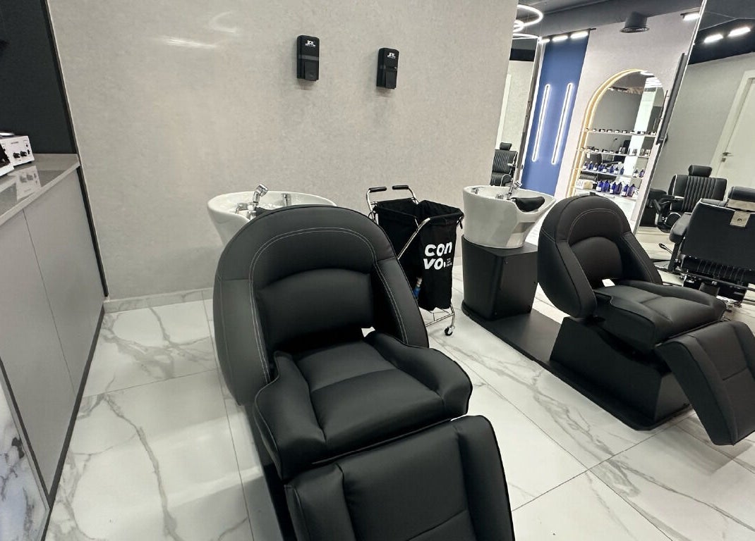 Luxurious wash area with black reclining chairs at Convo, Amman, Amman Governorate, JO.