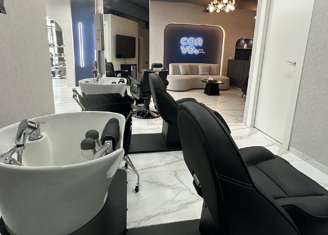 Chic salon space at Convo, Amman, Amman Governorate, JO with sleek washing stations and modern decor.