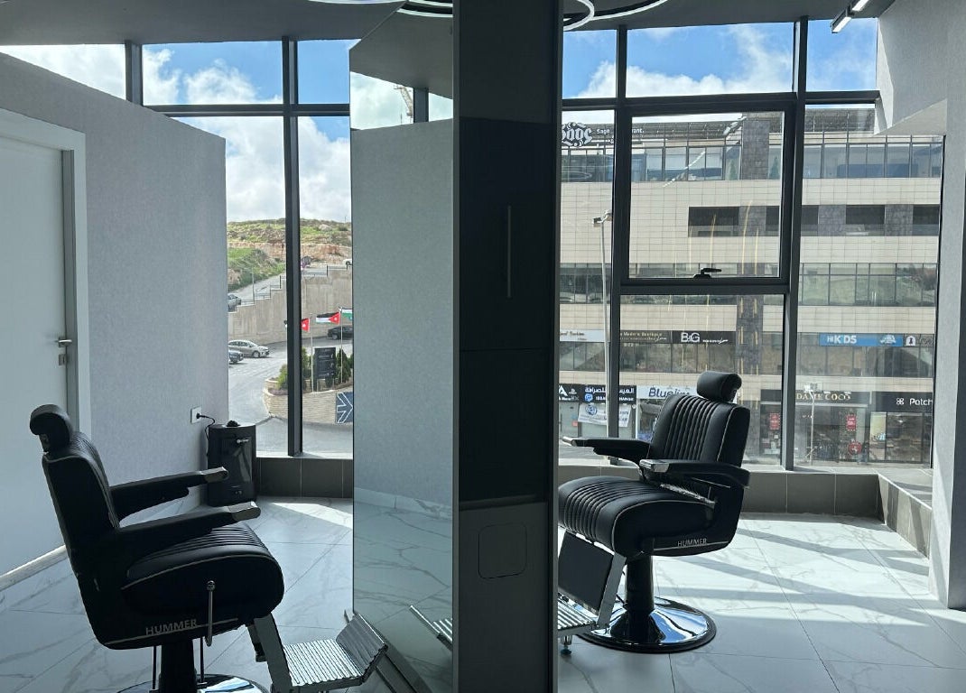 Modern barber chairs at Convo, Amman, Amman Governorate, JO, with stylish interior and cityscape view.