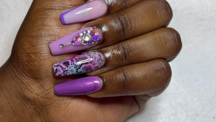 Stylish purple and pink nail art with gems at STUDIO 10, FREEPORT, Grand Bahama, BS.