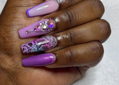 Stylish purple and pink nail art with gems at STUDIO 10, FREEPORT, Grand Bahama, BS.