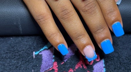 Manicured nails with bright blue polish at STUDIO 10, FREEPORT, Grand Bahama, BS.