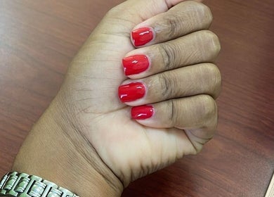 Vibrant red manicure at STUDIO 10, FREEPORT, Grand Bahama, BS. Showcasing beauty and wellness.