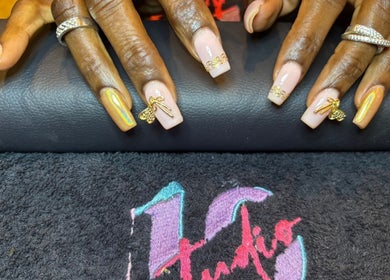 Stylish nail art with gold accents at STUDIO 10, FREEPORT, Grand Bahama, BS.