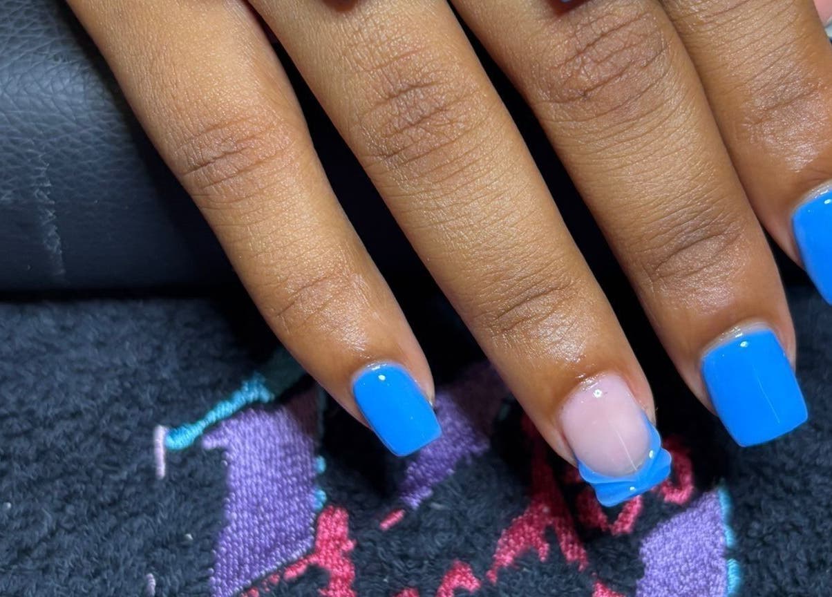 Bright blue manicured nails at STUDIO 10, FREEPORT, Grand Bahama, BS. Stylish nail design showcased.