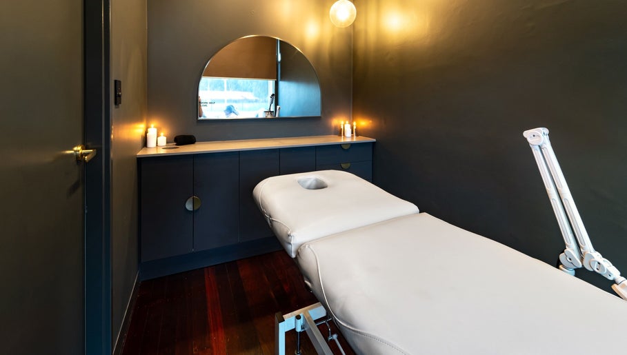 Serene treatment room at Breathe Beauty, Wembley, Western Australia, featuring a massage table and calming decor.