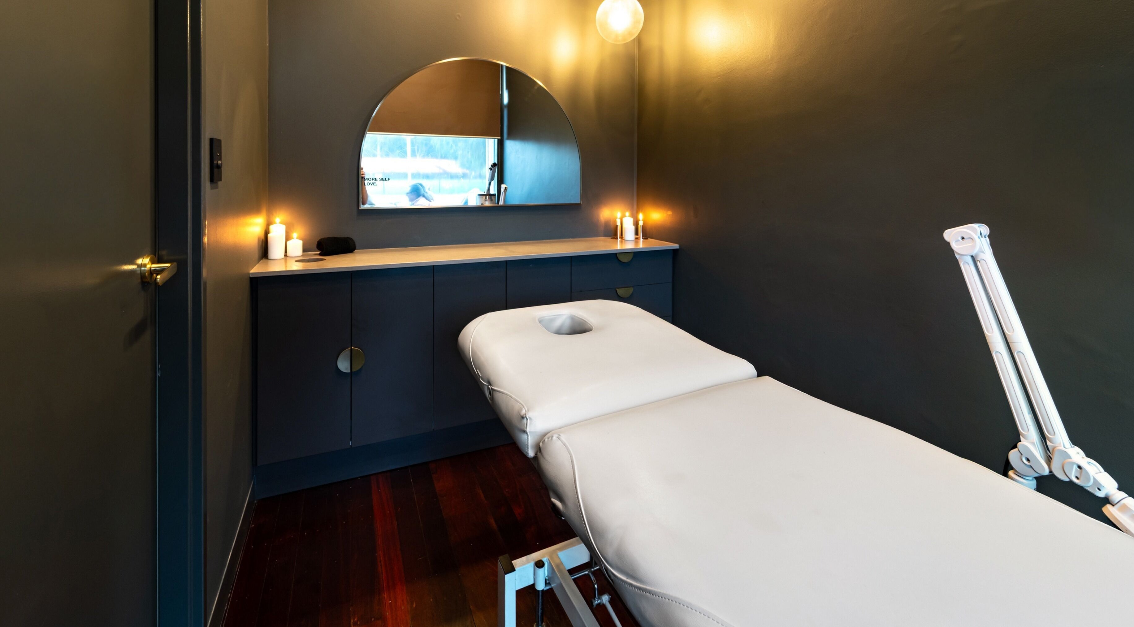 Serene treatment room at Breathe Beauty, Wembley, Western Australia, featuring a massage table and calming decor.