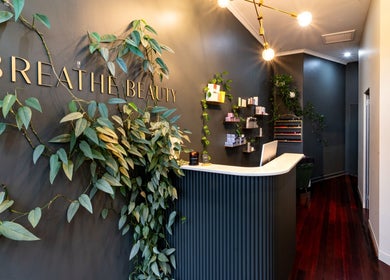 Elegant reception at Breathe Beauty in Wembley, Western Australia, AU with lush greenery and sleek design.