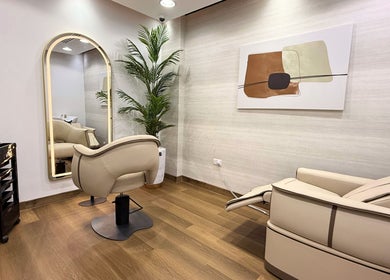 Luxurious interior of Luca Piattelli Hair Fixing Center, Dubai, AE, featuring sleek chairs and elegant decor.