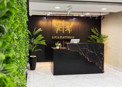 Elegant reception at Luca Piattelli Hair Fixing Center in Dubai, Dubai, AE, showcasing modern design and greenery.
