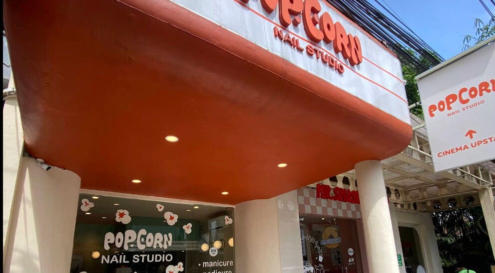 Popcorn Nail Studio entrance in Bali, ID, featuring the stylish storefront and vibrant signage.