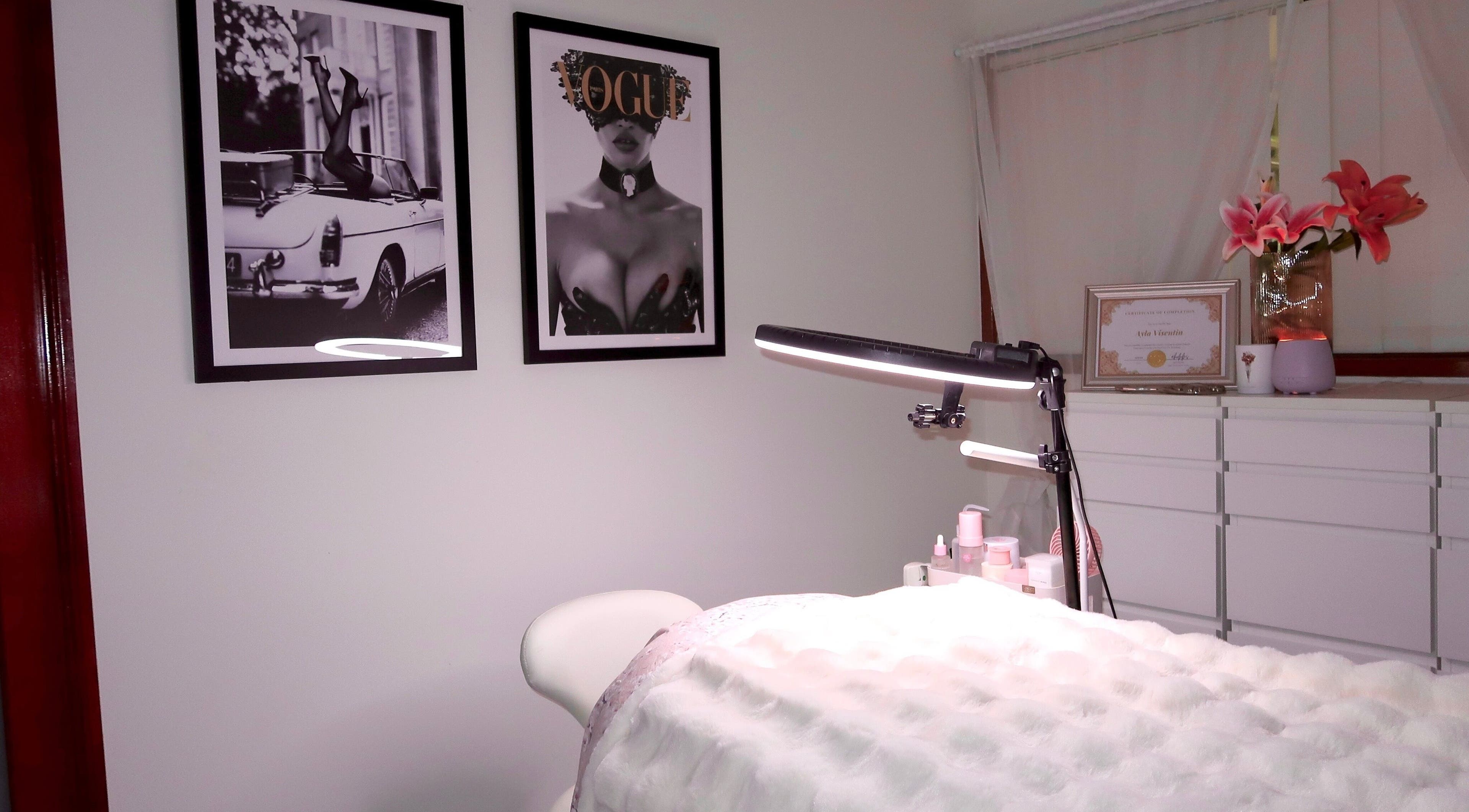 Cozy treatment room at Herhaus of Beauty in Oxenford, Queensland, AU with elegant wall art and lighting.