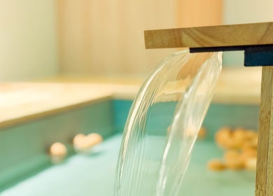 Tranquil spa waterfall at Haru Fit Tokyo in Jakarta Selatan, DKI Jakarta, ID, creating a serene atmosphere.