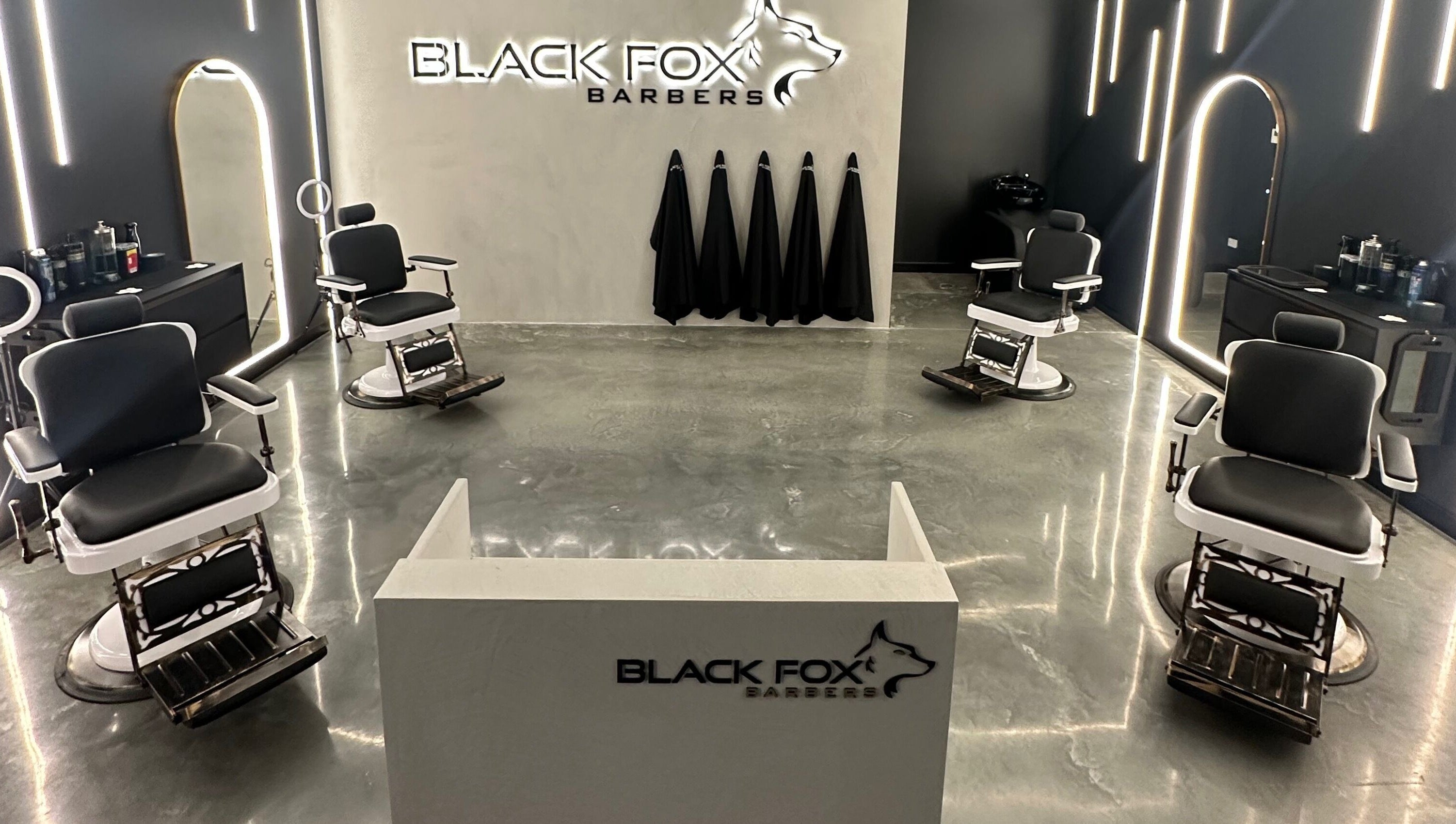 Modern interior of Black Fox Barbers in Pimpama, Queensland, AU, featuring sleek barber chairs and stylish decor.