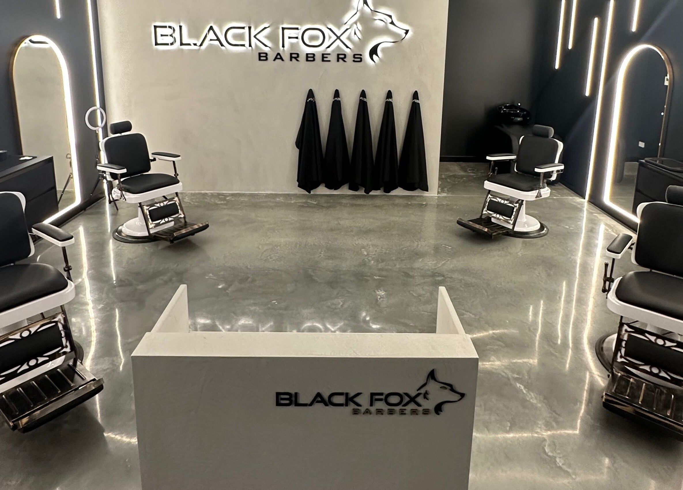 Modern interior of Black Fox Barbers in Pimpama, Queensland, AU, featuring sleek barber chairs and stylish decor.