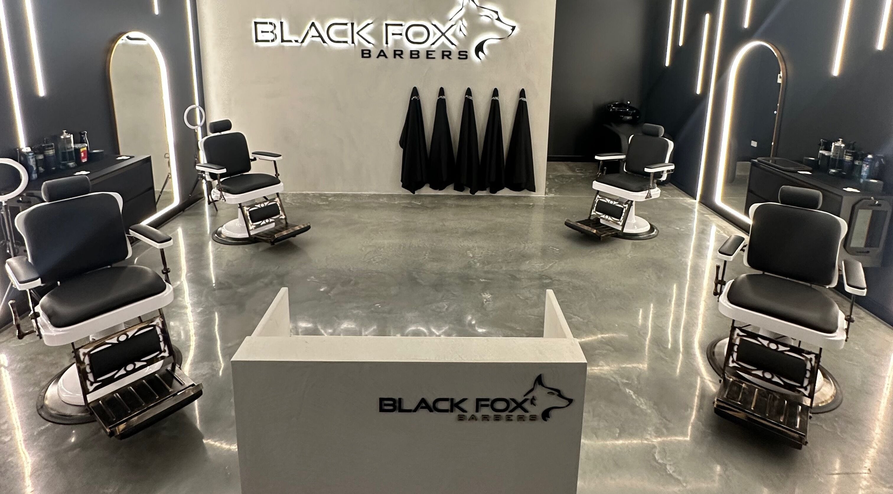 Modern interior of Black Fox Barbers in Pimpama, Queensland, AU, featuring sleek barber chairs and stylish decor.