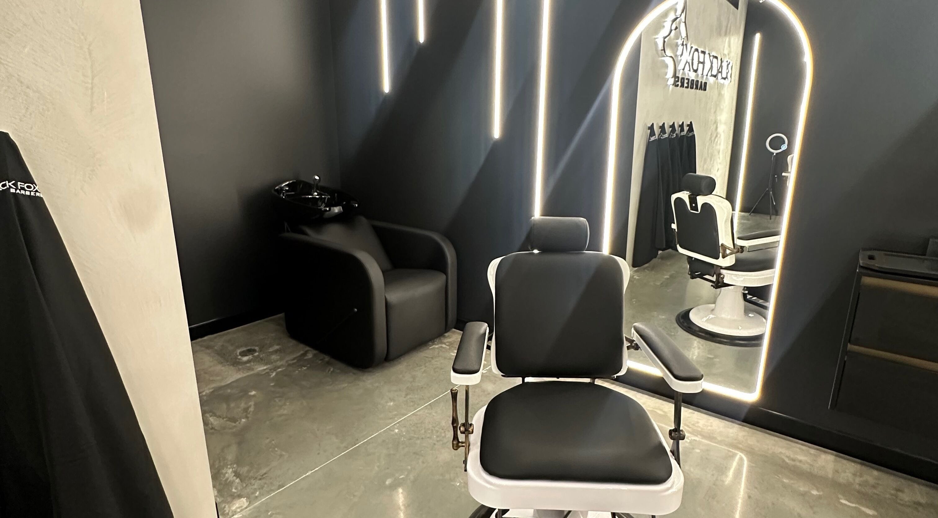 Modern barber chair at Black Fox Barbers, Pimpama, Queensland, AU, illuminated by sleek lighting and elegant decor.