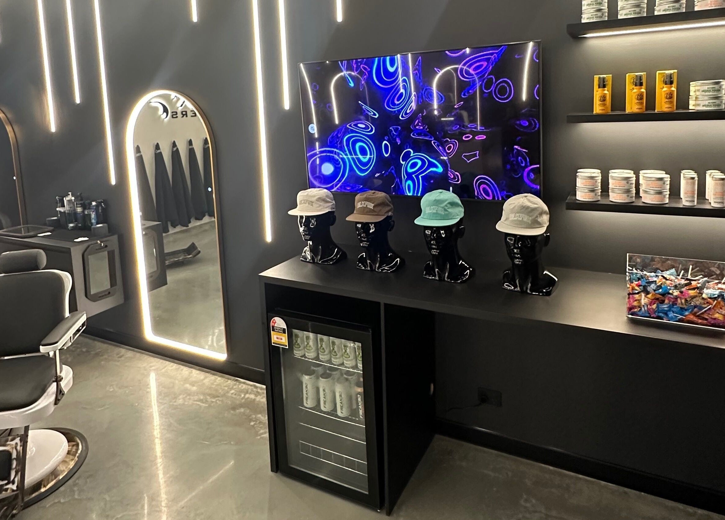 Chic interior of Black Fox Barbers in Pimpama, Queensland featuring modern decor and vibrant lighting.