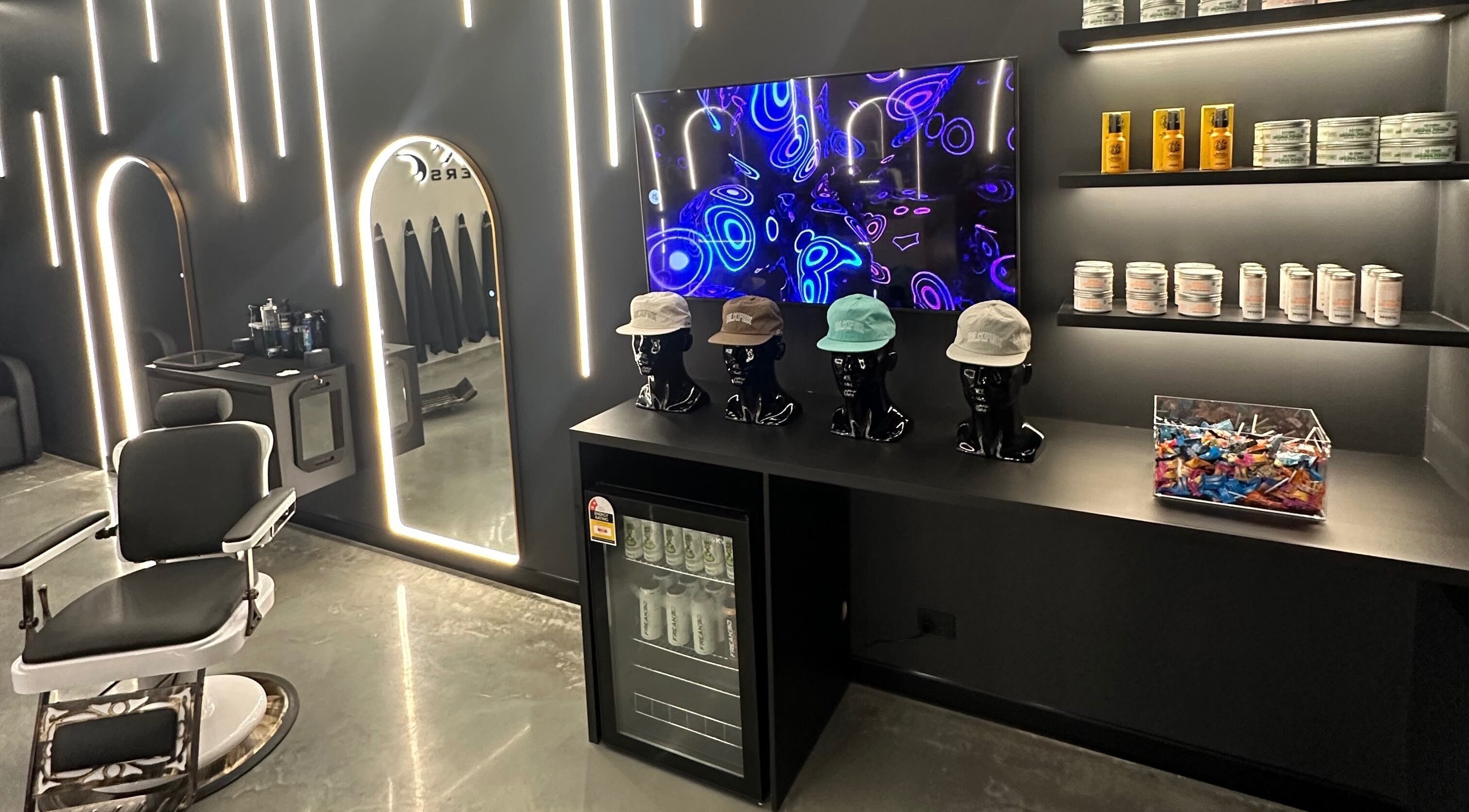 Chic interior of Black Fox Barbers in Pimpama, Queensland featuring modern decor and vibrant lighting.