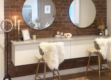 Chic vanity area at JAYA Beauty, Horbury Bridge, England, GB with mirrors and plush seating.