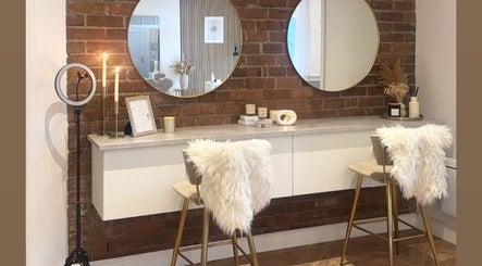 Chic vanity area at JAYA Beauty, Horbury Bridge, England, GB with mirrors and plush seating.