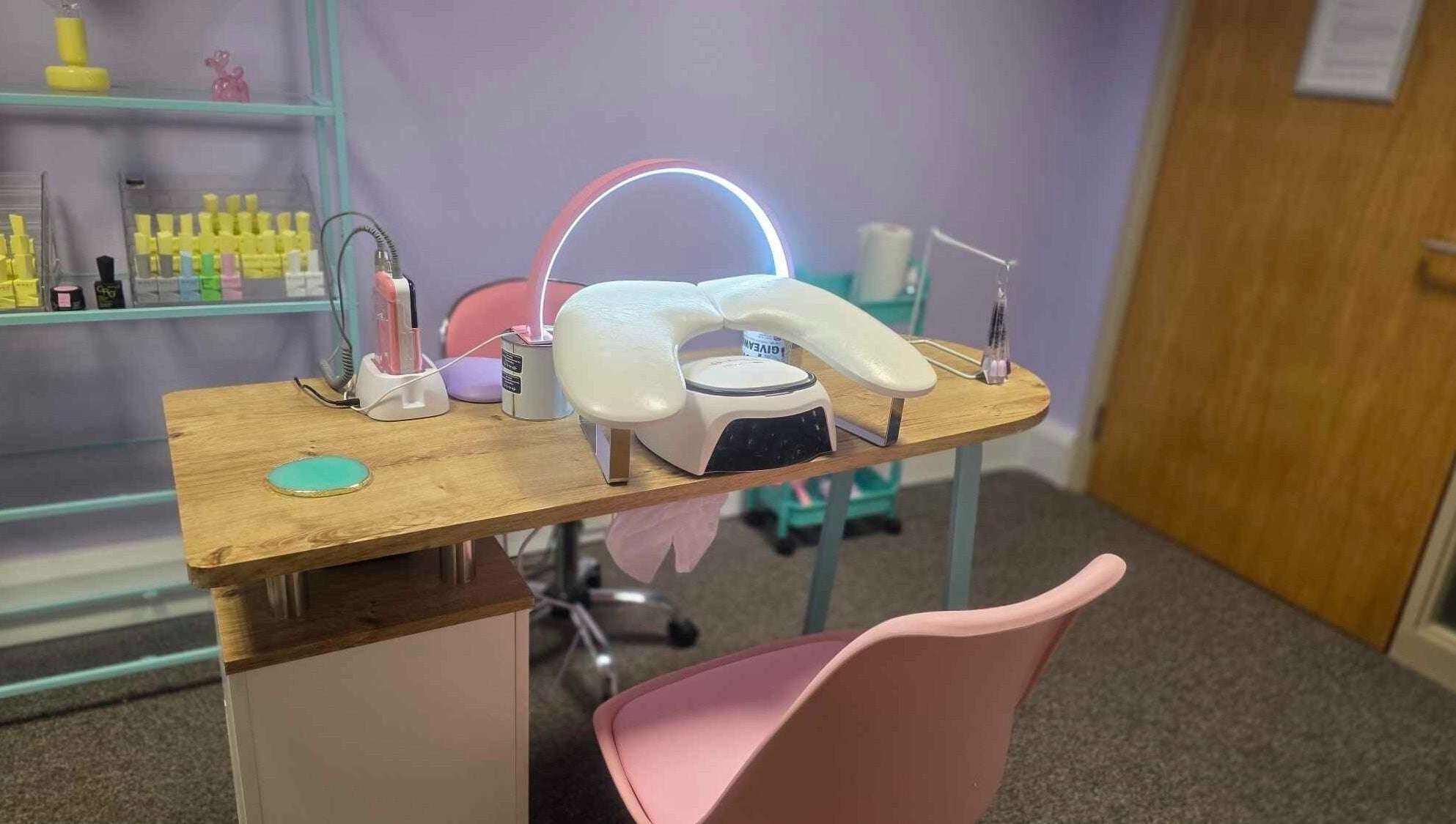 Modern nail station at LM Elixirs & Nails, Newhaven, England, GB, featuring sleek equipment and pastel decor.