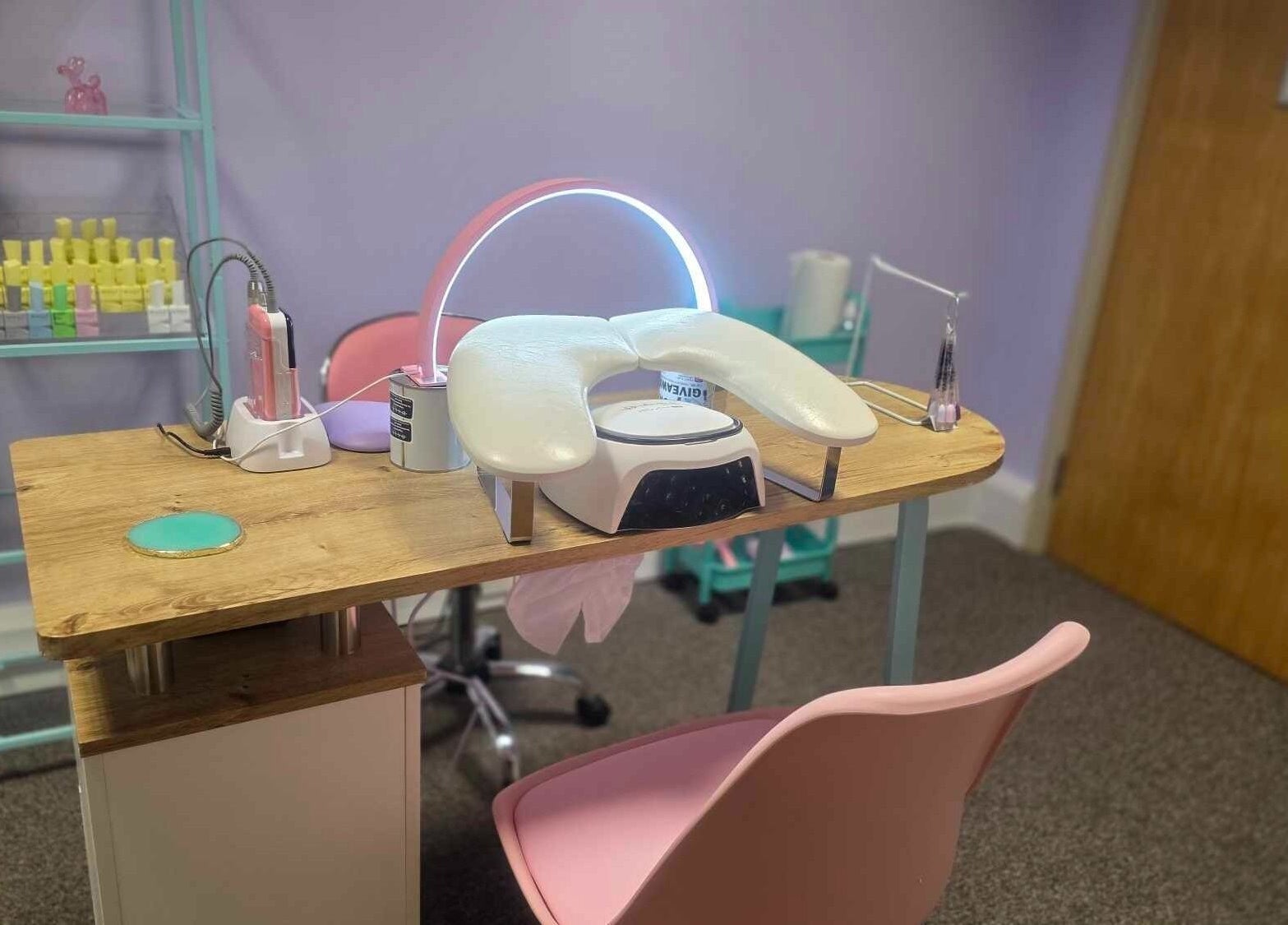 Modern nail station at LM Elixirs & Nails, Newhaven, England, GB, featuring sleek equipment and pastel decor.