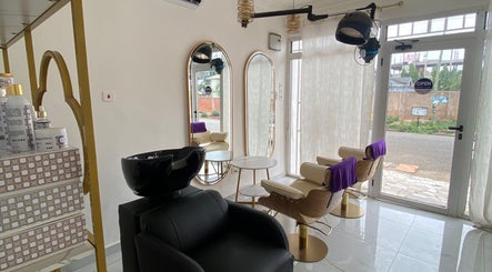Stylish interior of Nappytalia Salon in Accra, Greater Accra Region, GH featuring mirrors and seating.