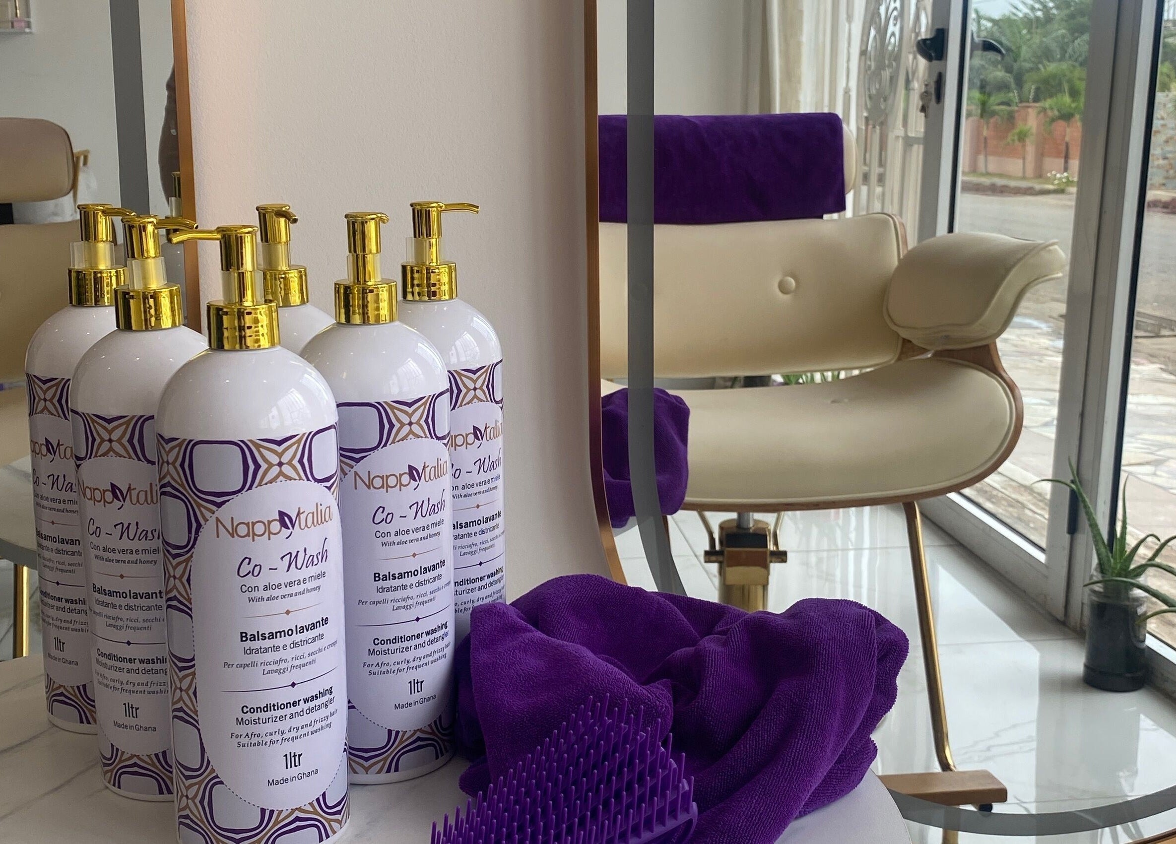 Nappytalia Salon in Accra featuring co-wash products on elegant marble display table.