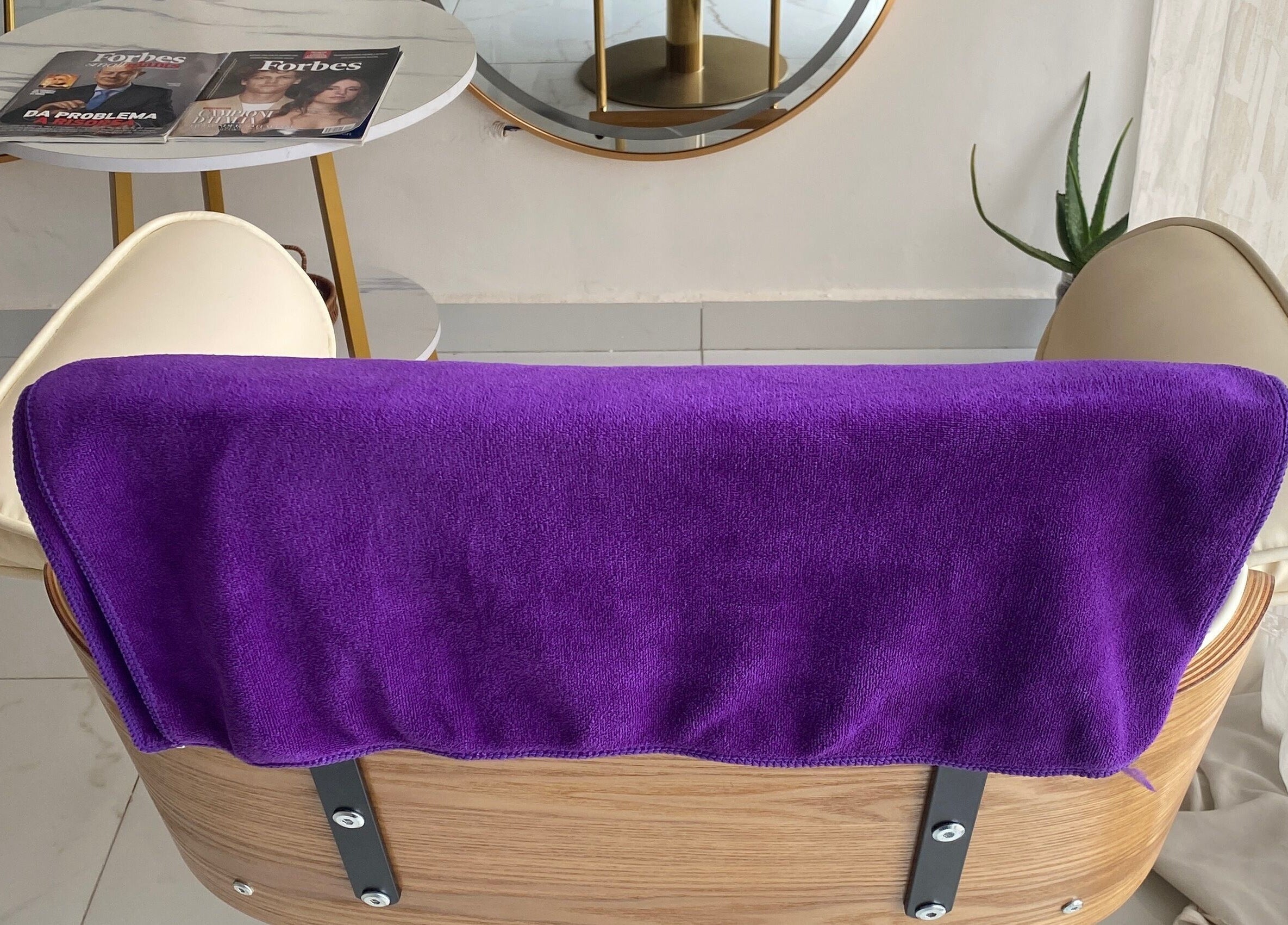 Elegant salon chair at Nappytalia Salon, Accra, Greater Accra Region, GH with purple towel and stylish decor.