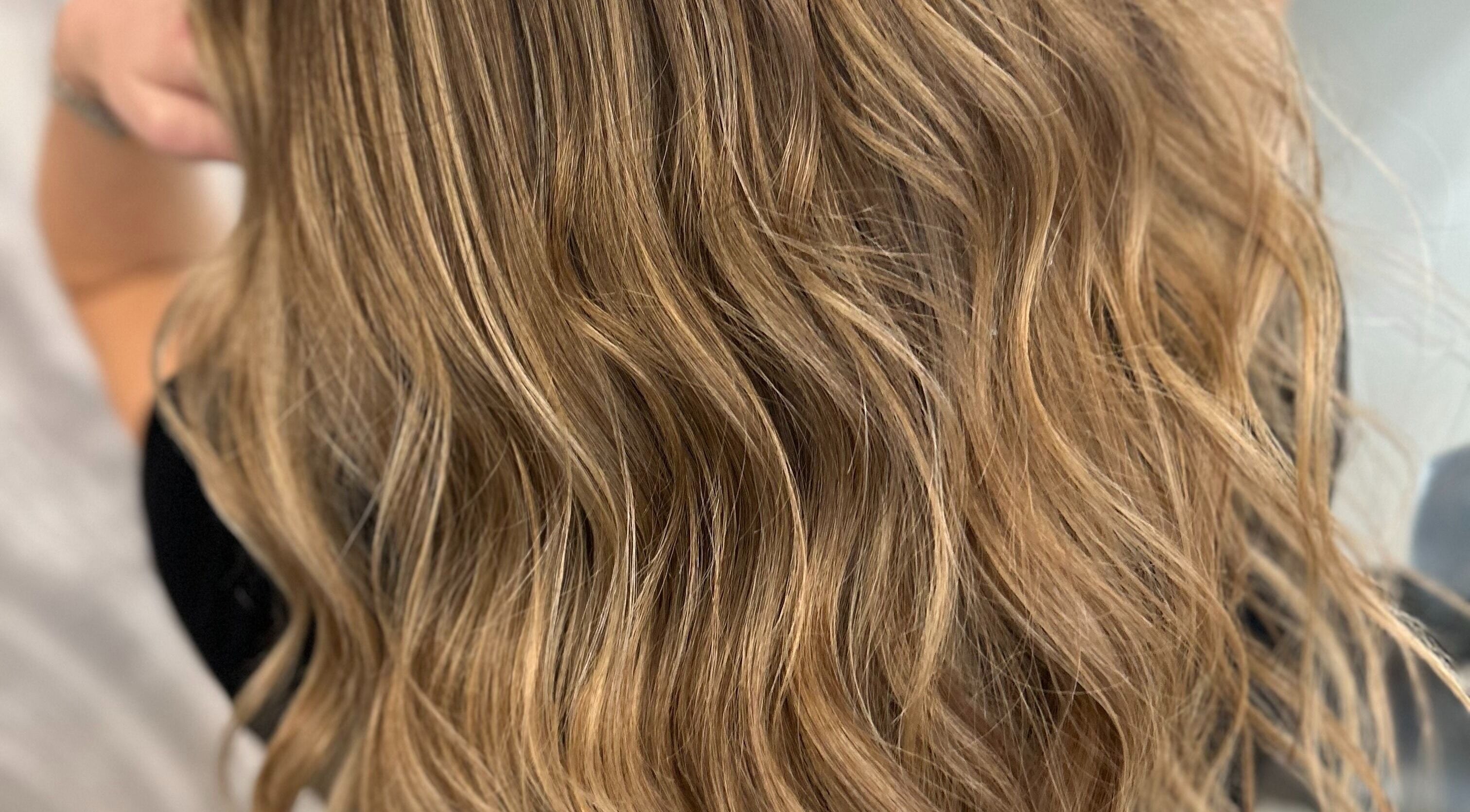 Elegant wavy hairstyle by Hair By Gerda in Portlaoise, County Laois, IE, showcasing glossy blonde tones.