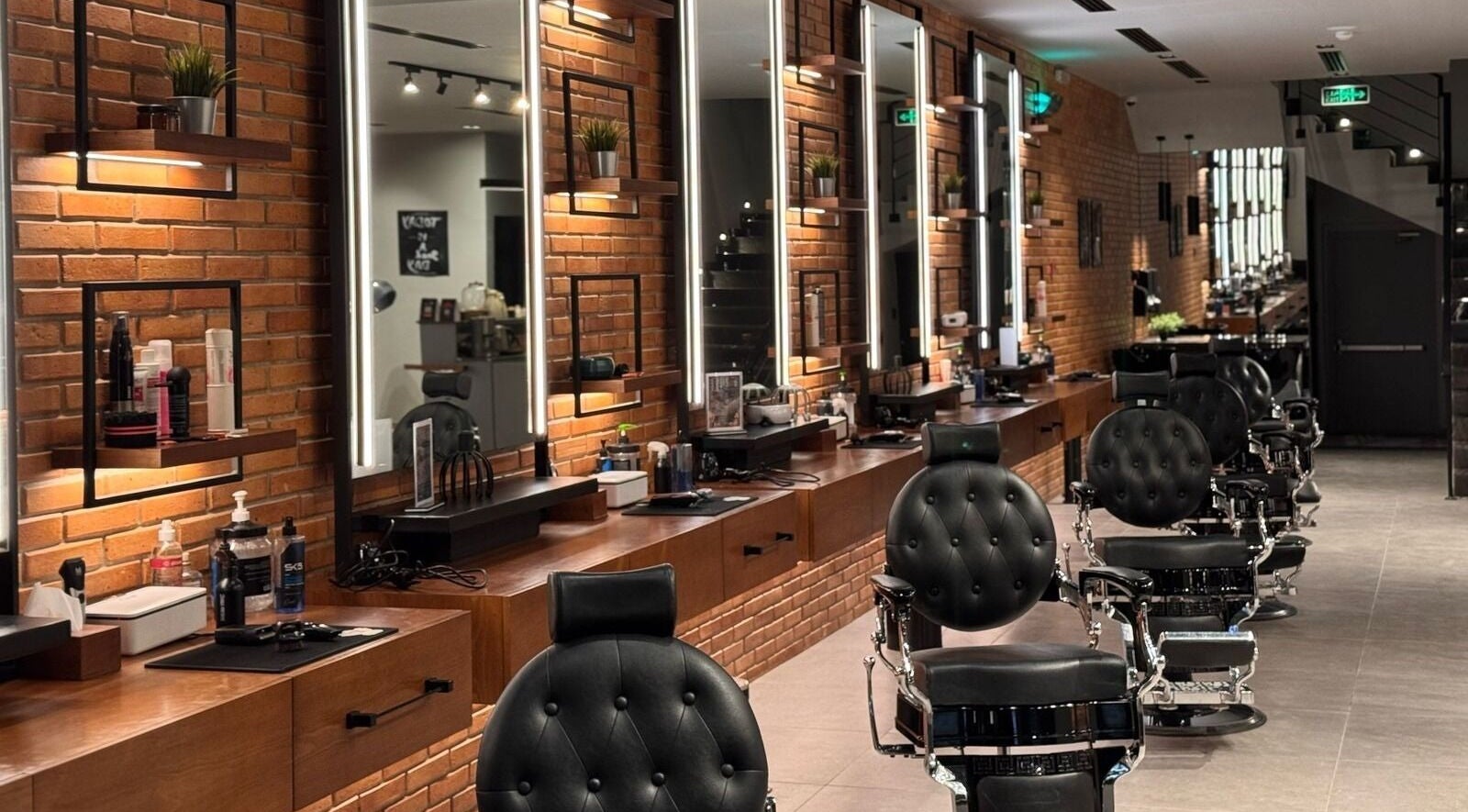 Interior of D Van Barbershop, Riyadh with modern chairs and mirrors, showcasing elegance in Riyadh Province, SA.