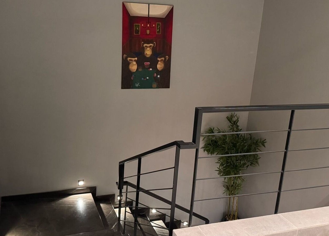 Elegant staircase at D Van Barbershop, Riyadh, featuring modern art and sleek design.
