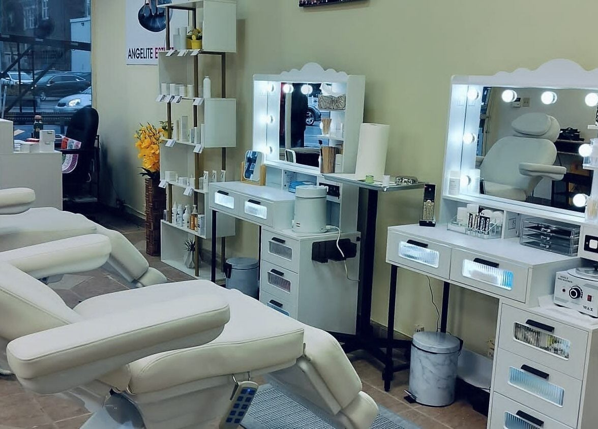 Chic beauty treatment room at Angelite Esthetics in Toronto, Ontario, CA with plush chairs and illuminated mirrors.