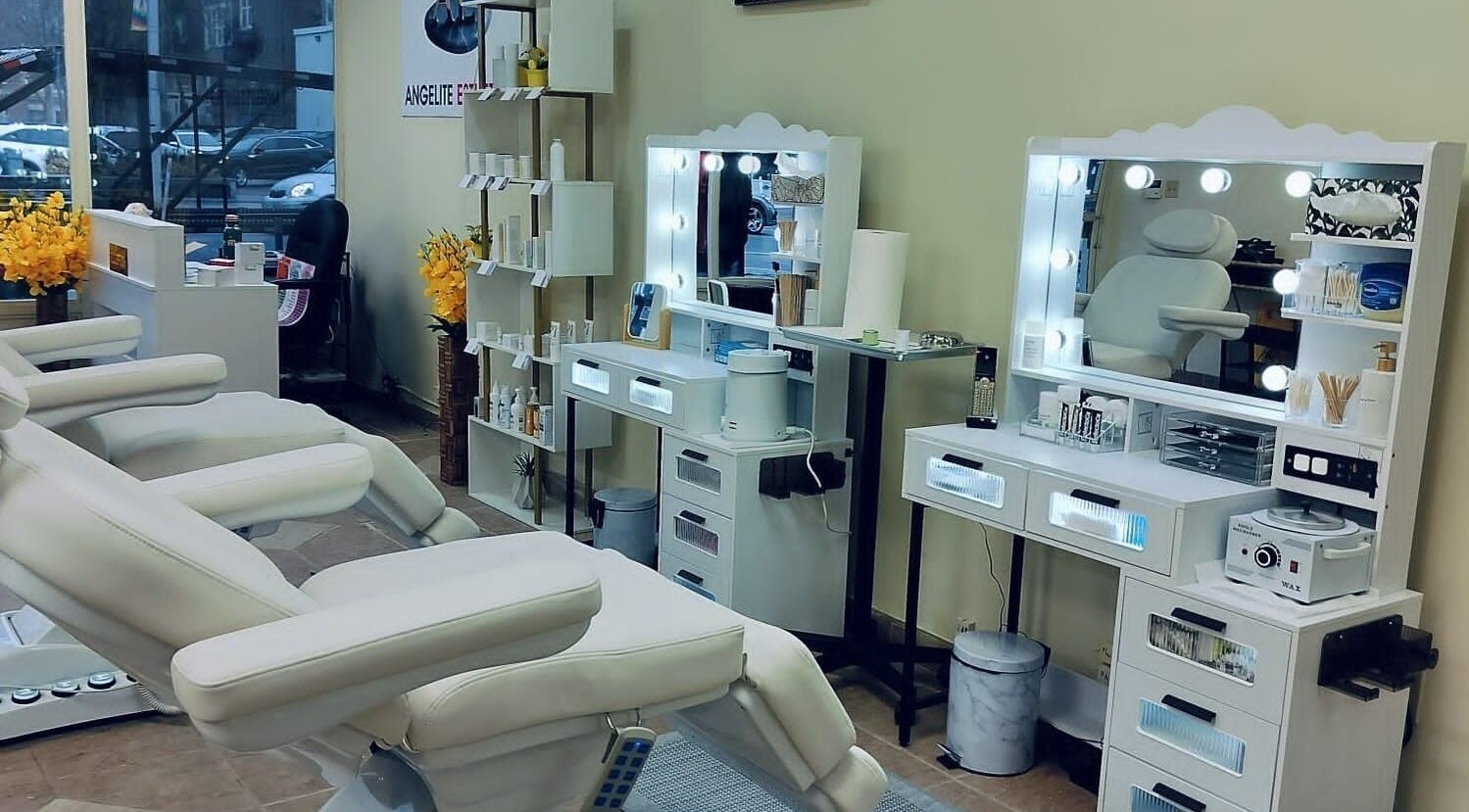 Chic beauty treatment room at Angelite Esthetics in Toronto, Ontario, CA with plush chairs and illuminated mirrors.