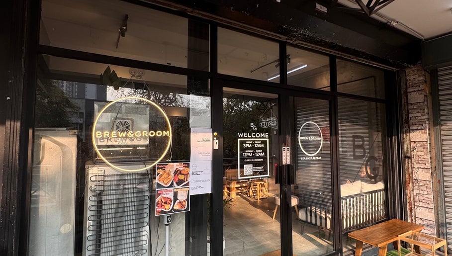 Entrance of Brew&Groom (Barber & Coffee Gombak) in Kuala Lumpur, MY showcasing glass doors and signage.