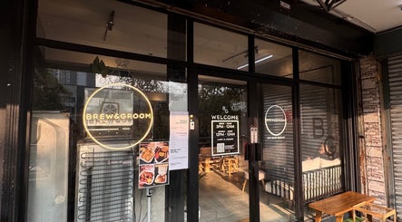 Entrance of Brew&Groom (Barber & Coffee Gombak) in Kuala Lumpur, MY showcasing glass doors and signage.