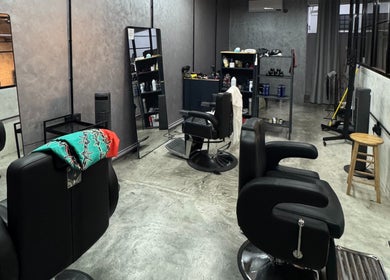 Modern barbershop interior at B&G by Brew&Groom in Kuala Lumpur, featuring stylish chairs and mirrors.