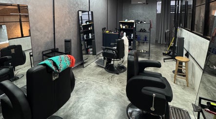 Modern barbershop interior at B&G by Brew&Groom in Kuala Lumpur, featuring stylish chairs and mirrors.