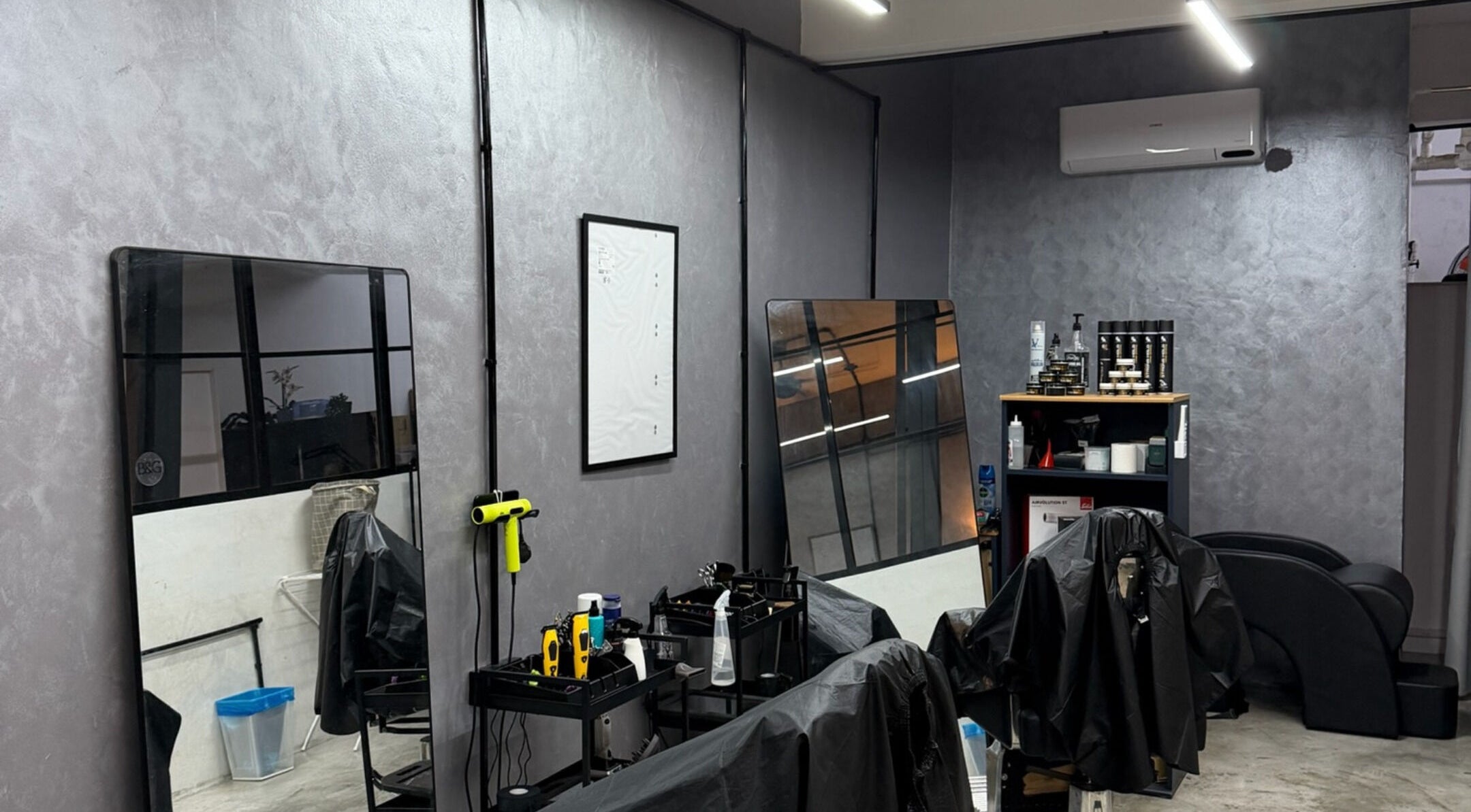 Stylish salon interior at B&G KL by Brew&Groom in Kuala Lumpur, featuring mirrors and modern design.