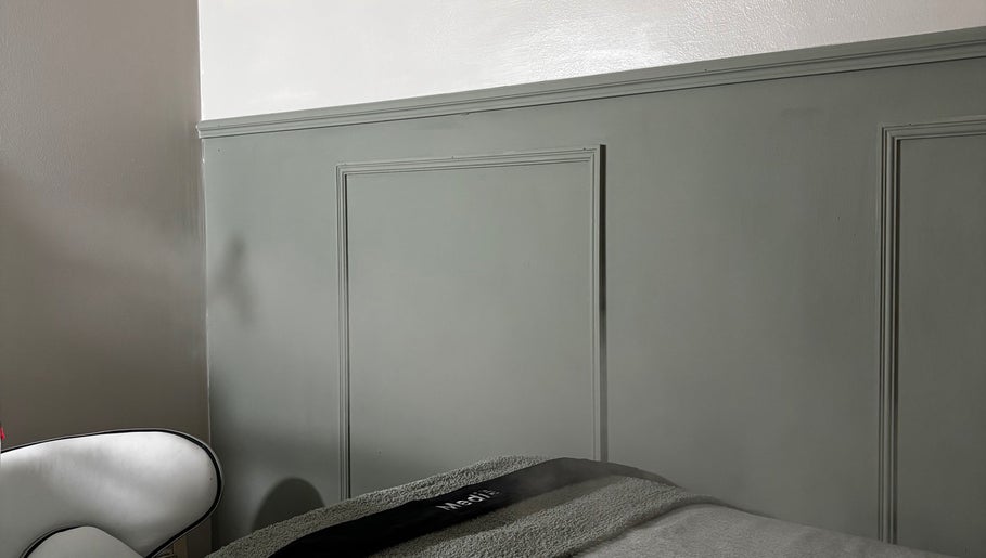 Calm therapy room at Bare Skin Clinic, Ashington, England, GB with a comfortable chair and bed.