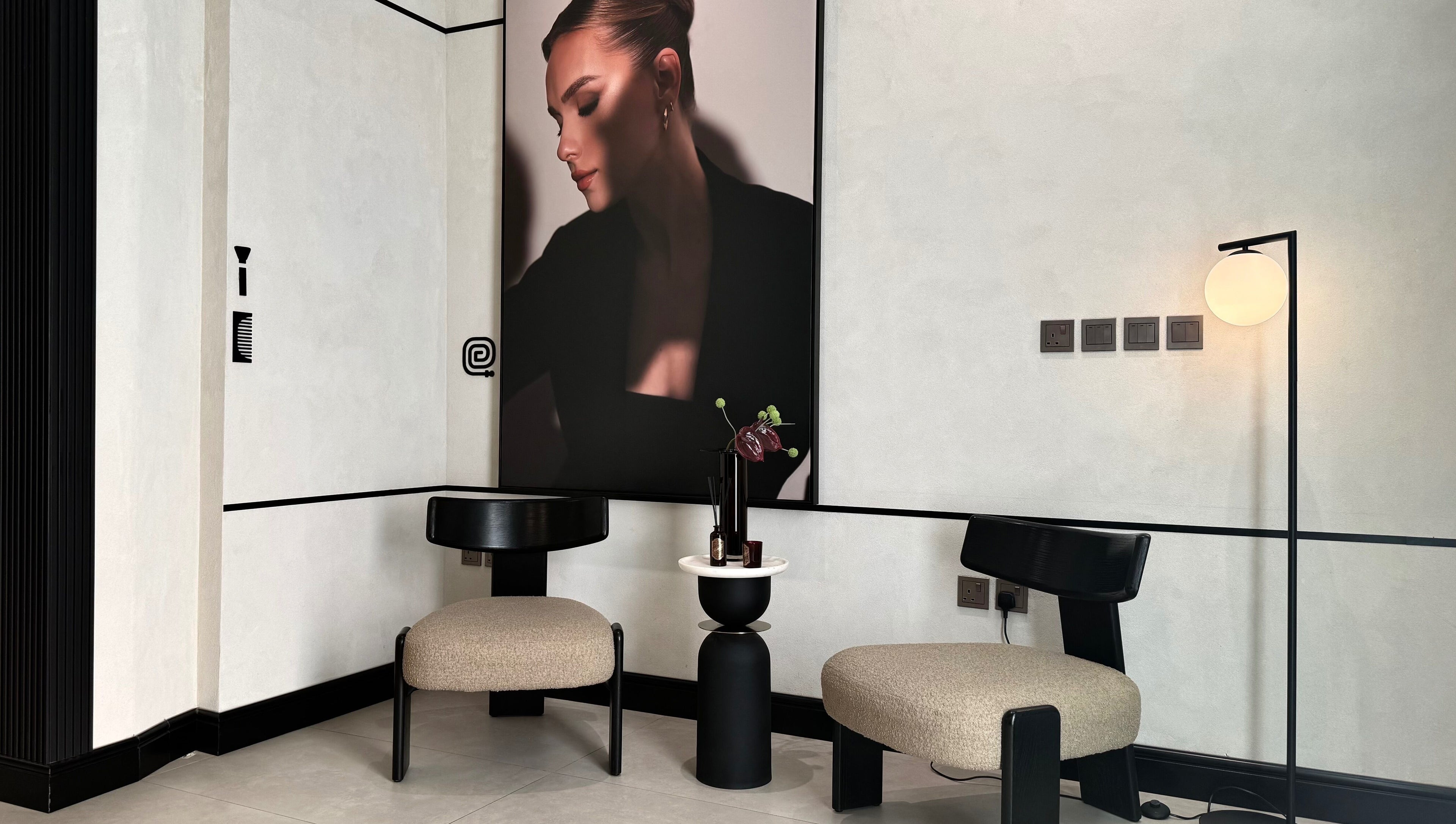 Modern lounge area at We Salon, Riyadh, Riyadh Province, SA, featuring elegant chairs and a sleek decor.