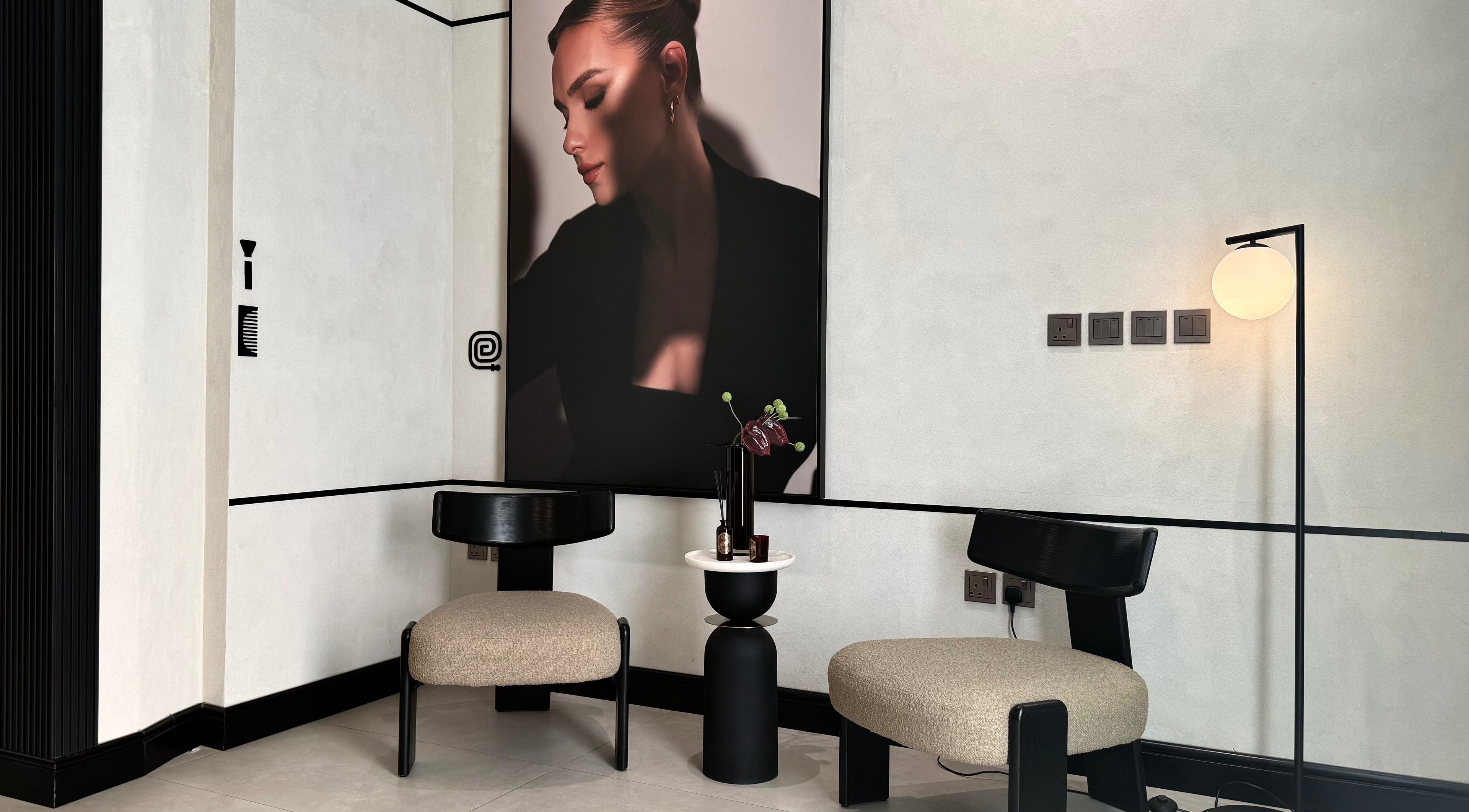 Modern lounge area at We Salon, Riyadh, Riyadh Province, SA, featuring elegant chairs and a sleek decor.