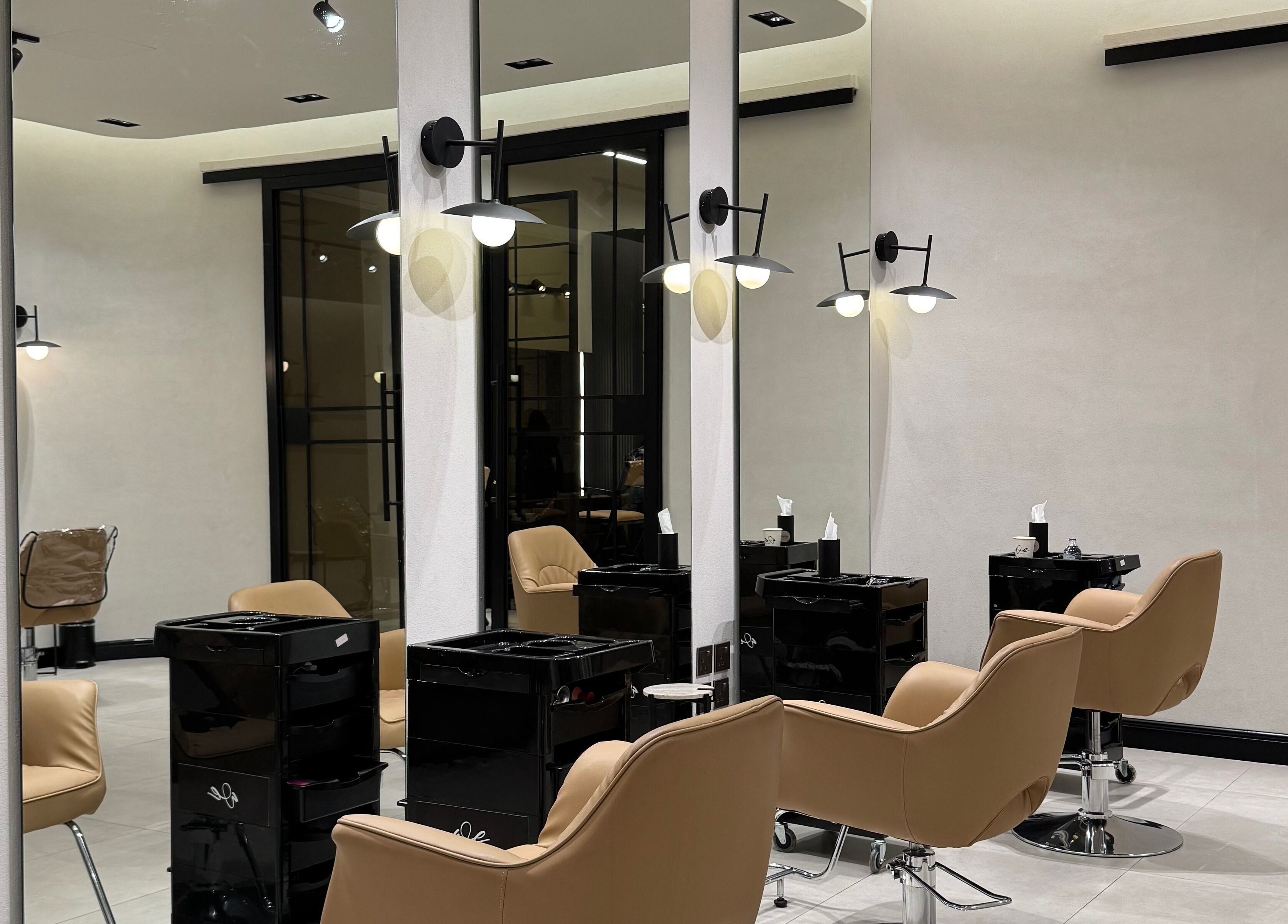 Modern salon interior at We Salon in Riyadh, Riyadh Province, SA, featuring stylish chairs and mirrors.