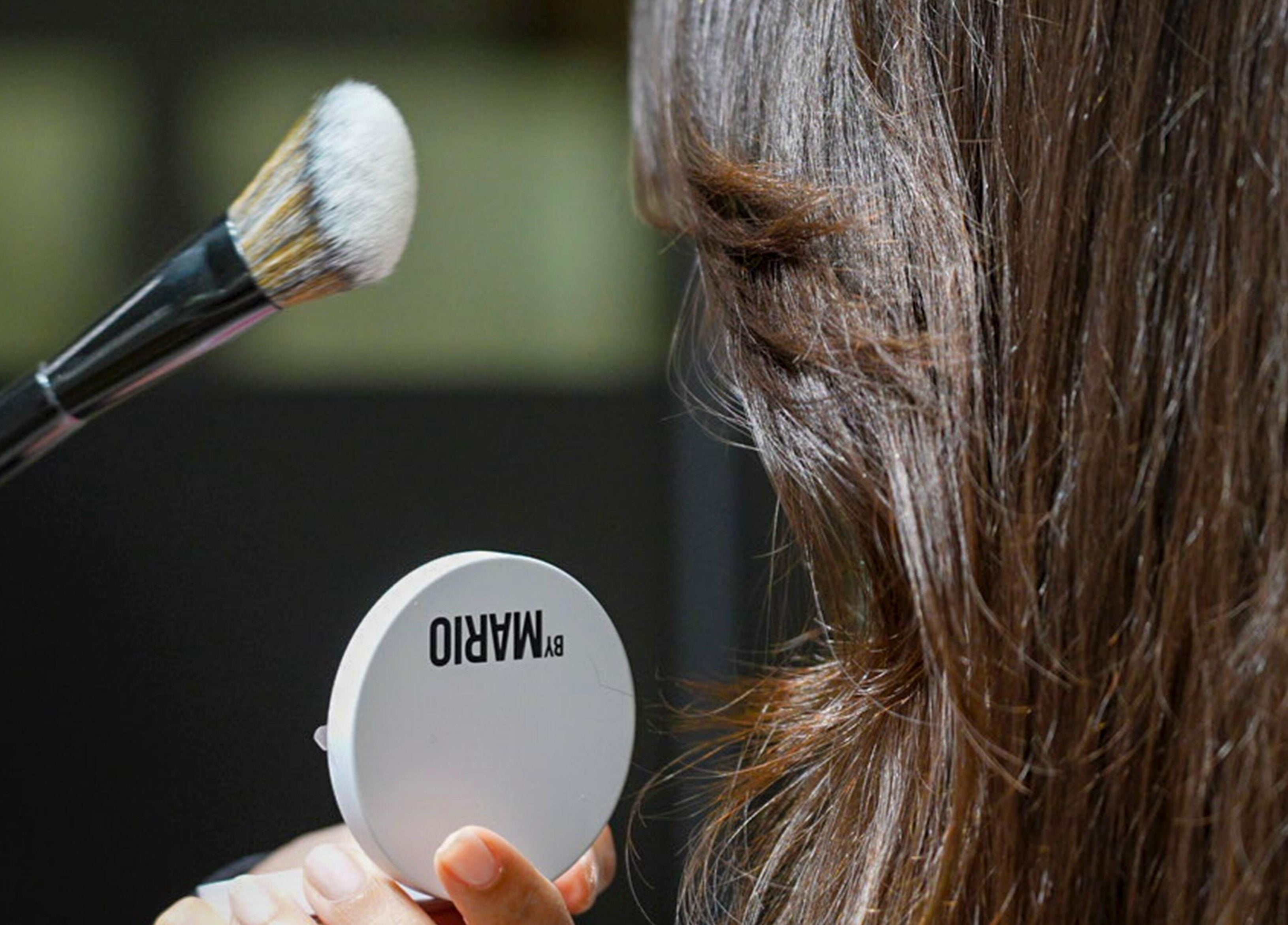 Makeup brush and mirror at We Salon, Riyadh, Riyadh Province, SA for a flawless look.