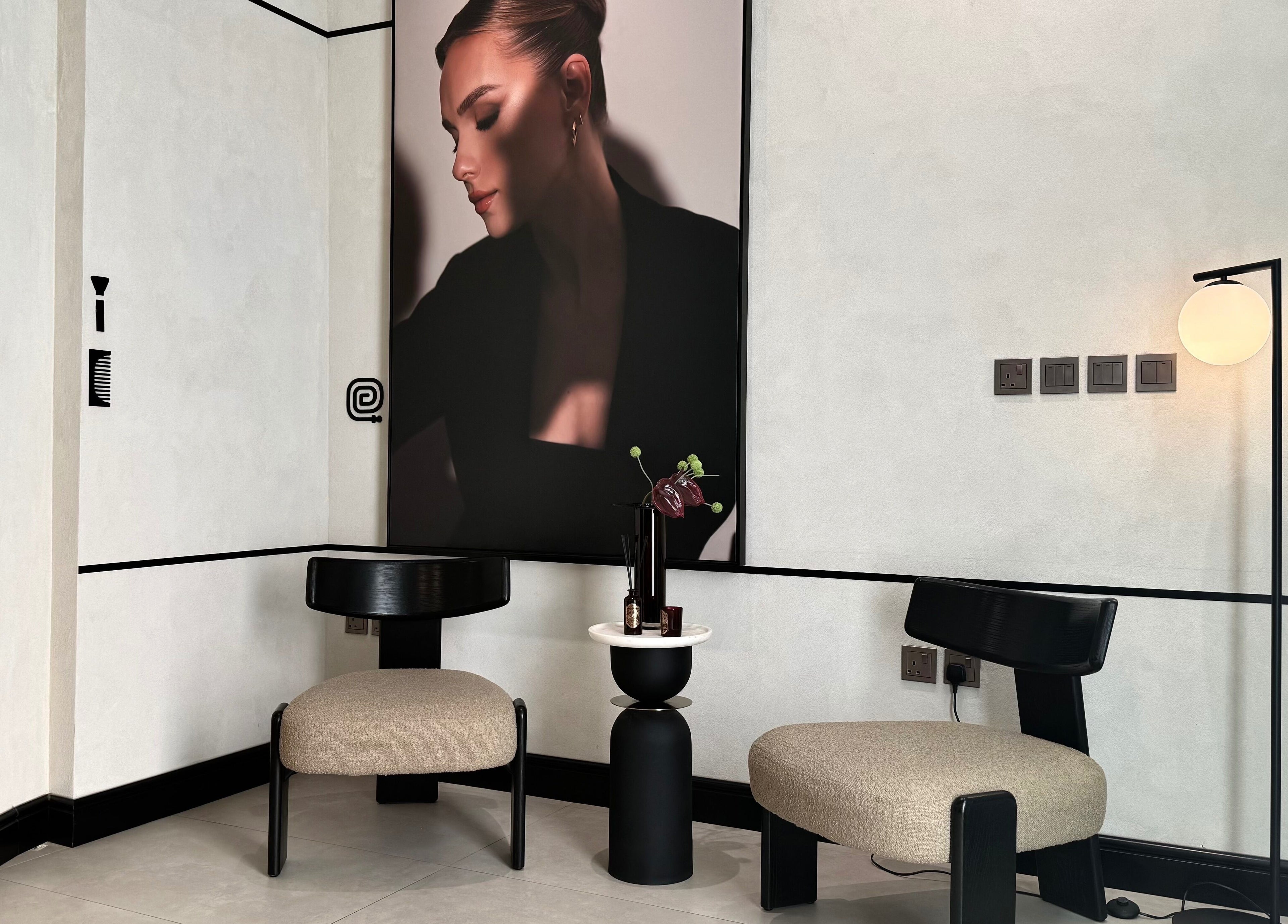 Chic seating area at We Salon, Riyadh featuring modern decor and a wall poster in Riyadh Province, SA.