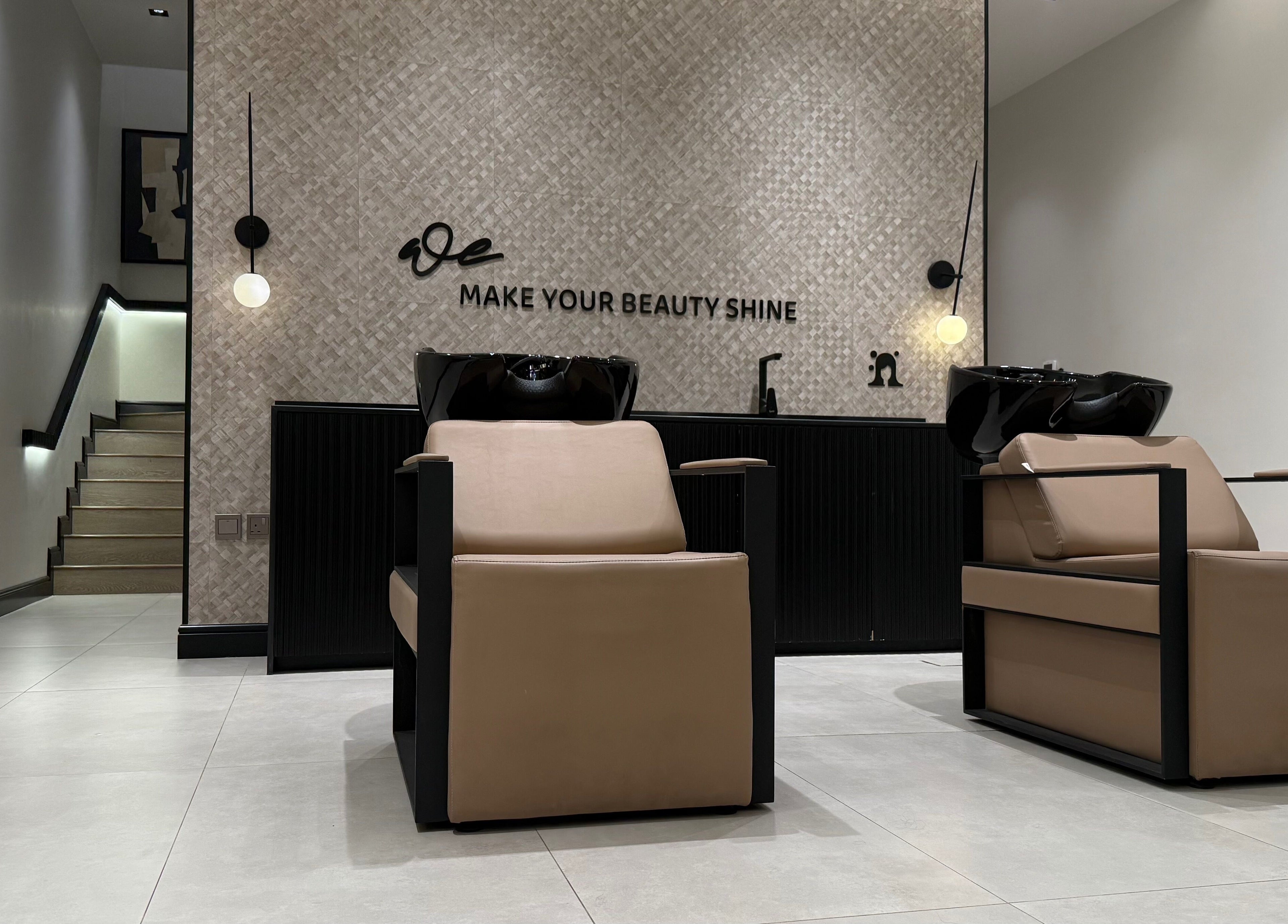 Modern salon interior at We Salon, Riyadh, Riyadh Province, SA showcasing chic hair-washing stations.